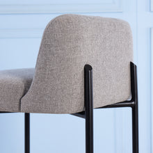 Load image into Gallery viewer, Gray upholstered chair with black metal legs against a light blue background
